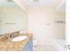 Second bathroom with granite vanity and tub at 1932 Lake Atriums Cir # 86, Orlando, FL 32839