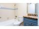 Bathroom features granite countertop, blue vanity, and shower/tub combo at 1932 Lake Atriums Cir # 86, Orlando, FL 32839