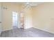 Bedroom with grey tile floors, access to bathroom and closet at 1932 Lake Atriums Cir # 86, Orlando, FL 32839