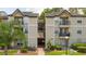 Two-story apartment building with exterior staircase and landscaping at 1932 Lake Atriums Cir # 86, Orlando, FL 32839