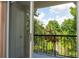 Private balcony overlooking lush green trees and a pond at 1932 Lake Atriums Cir # 86, Orlando, FL 32839