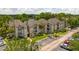 Apartment buildings with parking lot and surrounding trees, aerial view at 1932 Lake Atriums Cir # 86, Orlando, FL 32839