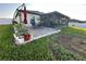 Backyard with patio, landscaping, and grassy area at 1908 Piedmont Ct, Mascotte, FL 34753