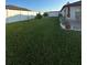 Large grassy backyard with patio and partial fence view at 1908 Piedmont Ct, Mascotte, FL 34753
