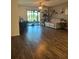 Living room with sliding doors to patio and hardwood floors at 1908 Piedmont Ct, Mascotte, FL 34753