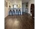 Open living area with kitchen bar and hardwood floors at 1908 Piedmont Ct, Mascotte, FL 34753