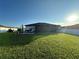Large backyard with grassy area and patio at 1908 Piedmont Ct, Mascotte, FL 34753