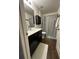 Clean bathroom with dark vanity, shower, and tile floor at 1908 Piedmont Ct, Mascotte, FL 34753