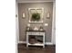 Entryway with console table, decor, and hardwood floors at 1908 Piedmont Ct, Mascotte, FL 34753