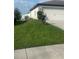 Landscaped yard with driveway and attached garage at 1908 Piedmont Ct, Mascotte, FL 34753