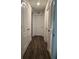 Bright hallway with hardwood floors and multiple doors at 1908 Piedmont Ct, Mascotte, FL 34753