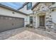 Inviting exterior with stone accents and a two-car garage at 11684 Hampstead St, Windermere, FL 34786