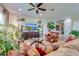 Bright living room with comfy seating, large TV, and plenty of plants at 16486 Blooming Cherry Dr, Groveland, FL 34736