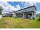 Two-story house exterior with covered patio and well maintained lawn at 8324 Ludington Cir, Orlando, FL 32836