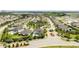 Aerial view of community with various houses, landscaping, and a lake at 8324 Ludington Cir, Orlando, FL 32836