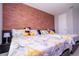 Bedroom with twin beds, brick accent wall, and ample closet space at 8324 Ludington Cir, Orlando, FL 32836