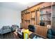 Home office with wood built-ins and comfortable seating at 8324 Ludington Cir, Orlando, FL 32836