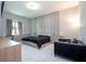 Modern bedroom with a large bed, built-in storage and marble floors at 8324 Ludington Cir, Orlando, FL 32836