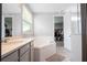 Bathroom with double vanity, soaking tub, and walk-in closet access at 8324 Ludington Cir, Orlando, FL 32836
