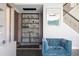 Elegant living room featuring a built-in shelving unit and comfy armchair at 8324 Ludington Cir, Orlando, FL 32836