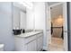 Bathroom with granite countertop, single sink, and access to upstairs hallway at 8324 Ludington Cir, Orlando, FL 32836