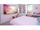 Stylish bedroom with a large TV and built-in shelving at 8324 Ludington Cir, Orlando, FL 32836