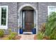 Elegant front door with stone accents and landscaping at 8324 Ludington Cir, Orlando, FL 32836