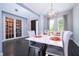 Bright dining room with modern chandelier and seating for six at 8324 Ludington Cir, Orlando, FL 32836
