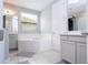 Spacious bathroom with corner bathtub, double sinks, and separate shower at 8324 Ludington Cir, Orlando, FL 32836