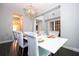 Elegant dining room features a modern chandelier and seating for six at 8324 Ludington Cir, Orlando, FL 32836