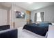 Primary bedroom with large TV, built-in storage and sitting area at 8324 Ludington Cir, Orlando, FL 32836