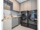 Laundry room with modern washer and dryer, and plenty of storage at 8324 Ludington Cir, Orlando, FL 32836