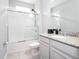 Clean bathroom with shower/tub combo, granite vanity, and tile flooring at 8324 Ludington Cir, Orlando, FL 32836