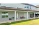 Covered patio, outdoor kitchen, and grassy backyard at 8324 Ludington Cir, Orlando, FL 32836
