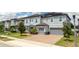 Two-story house with gray siding, solar panels, and two-car garage at 8324 Ludington Cir, Orlando, FL 32836
