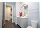Stylish bathroom with gray vanity and a view into adjacent laundry room at 8324 Ludington Cir, Orlando, FL 32836