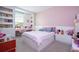 Charming bedroom with built-in shelving and a desk area at 8324 Ludington Cir, Orlando, FL 32836