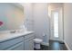 Modern bathroom with gray vanity, dark tile floors, and shower at 8324 Ludington Cir, Orlando, FL 32836