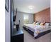 Bedroom with two twin beds, brick feature wall, and a window at 8324 Ludington Cir, Orlando, FL 32836
