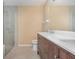Modern bathroom with double vanity, glass shower, and tiled floors at 1611 Sand Key Cir, Oviedo, FL 32765