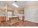 Modern kitchen with wood cabinets, island, and white appliances at 1611 Sand Key Cir, Oviedo, FL 32765