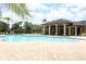 Community pool with patio furniture and covered seating area at 319 Morning View Dr, Winter Garden, FL 34787