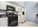 Black appliances and light wood cabinets in this galley kitchen at 101 N Hill Ave # 4, Deland, FL 32724
