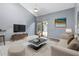 Living room with vaulted ceiling and access to the patio at 101 N Hill Ave # 4, Deland, FL 32724