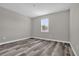 Spacious bedroom with gray walls and wood-look flooring at 1402 Persimmon Ave, Sanford, FL 32771