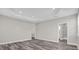 Spacious bedroom with wood-look floors and an en-suite bathroom at 1402 Persimmon Ave, Sanford, FL 32771