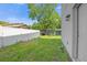 Landscaped backyard with a large tree and a fence at 1402 Persimmon Ave, Sanford, FL 32771
