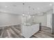 Open kitchen features a large island and gray laminate flooring at 1402 Persimmon Ave, Sanford, FL 32771