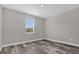 Bright bedroom featuring wood-look floors and a window with blinds at 1402 Persimmon Ave, Sanford, FL 32771