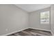 Simple bedroom with wood-look floors and a window at 1402 Persimmon Ave, Sanford, FL 32771